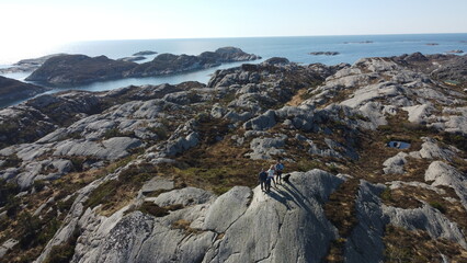 Norwegian mountains and Norwegian sea. Nature of Norway. Group of people hiking in the mountains