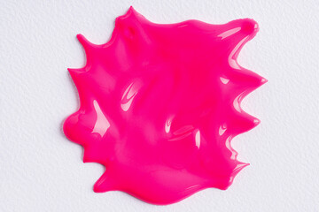The puddle of an pink paint spill over the white background