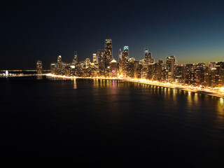 Fototapeta premium Aerial view of the downtown city of Chicago, Illinois, skyline at night. USA 2023