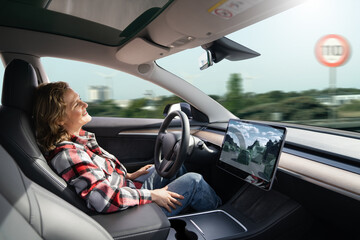 Woman resting while her car is driven by an autopilot. Self driving vehicle concept	