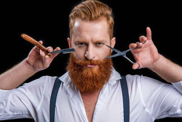 unshaven barber man with scissors and retro razor blade. photo of barber man on background.