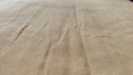 Abstract background and texture from yellow linen fabric, made from linen fibers