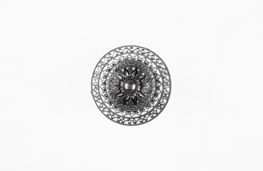 silver round brooch isolated on white background