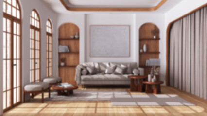 Blurred background, modern wooden living room with parquet and arched windows. Fabric sofa, carpets and armchairs. Boho style interior design