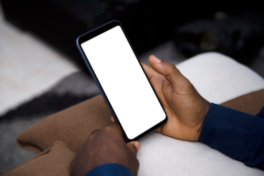 Black Hand holding mobile phone with transparent blank png screen in living room - Powered by Adobe