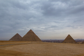 Fototapeta na wymiar The Great Pyramids of Giza with the hazy city of Cairo behind them.