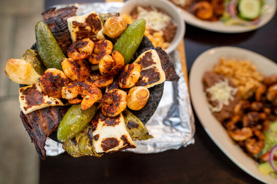 Close up of an authentic mexican food meal consisting of grilled shrimp and jalapenos