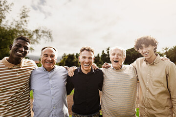 Happy multigenerational group of men with different ethnicities having fun smiling in front of camera at park - People diversity concept - 582239383