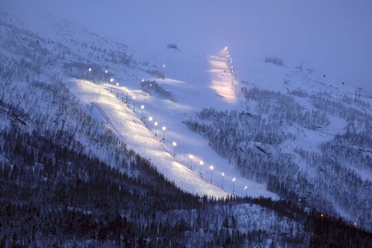 Ski slope in Narvik illuminated in the evening, Norway