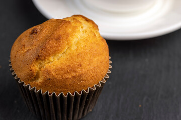 Soft and fresh fragrant wheat cupcake on a black stone