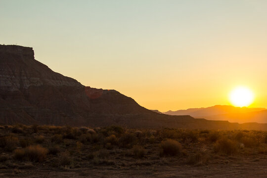 Sunsetting over the buttes and desert terrain in Virgin, Utah.
