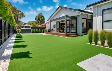 Fotobehang A contemporary Australian home or residential buildings front yard features artificial grass lawn turf with timber edging © Livinskiy