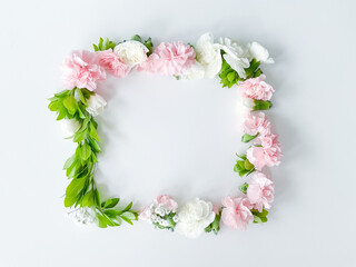 Square frame of pink and white carnations, leaves
