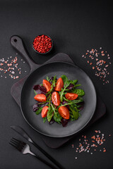 Salad of fresh cherry tomatoes, arugula, spinach and young beet leaves