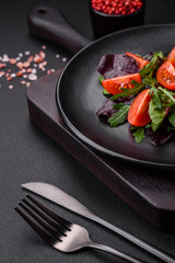 Salad of fresh cherry tomatoes, arugula, spinach and young beet leaves