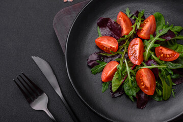 Salad of fresh cherry tomatoes, arugula, spinach and young beet leaves