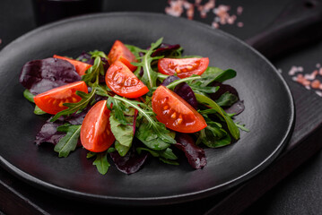 Salad of fresh cherry tomatoes, arugula, spinach and young beet leaves