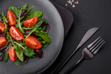 Salad of fresh cherry tomatoes, arugula, spinach and young beet leaves