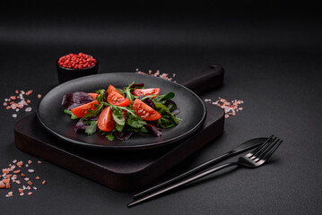Salad of fresh cherry tomatoes, arugula, spinach and young beet leaves