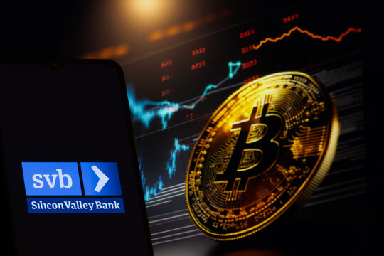 SVB ( Silicon Valley Bank) logo on blurred bitcoin background, March 17, 2023