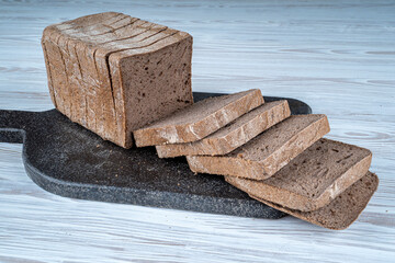 Gluten-free rectangular bread loaves. It is made with buckwheat flour, black cumin powder,...