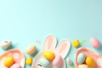 Happy Easter greeting card template. Frame border made of Easter eggs, plates, decoration on blue background.