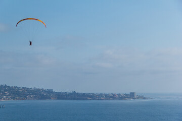 Gliding off the San Diego coast and over Blacks beach. Paragliding.