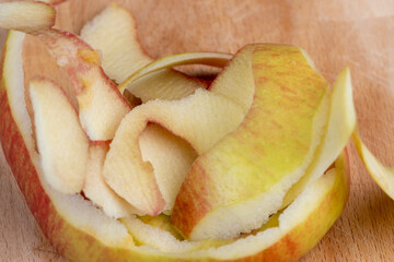 the peel of a peeled apple scattered on the board