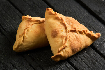 Tatar pie triangle echpochmak, Russian kurnik, delicious pastry with chicken and potatoes. Traditional food, quick snack of dough. © Евгений Вершинин
