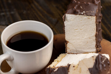 Fresh sweet cake with milk taste and aroma in chocolate glaze