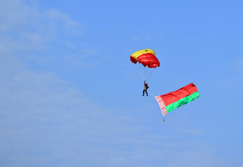 flying with a parachute on a summer day