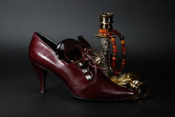 Still life with female shose, candlesticks, sunglasses, rosary beads