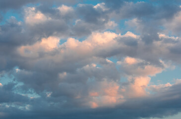 Clouds in the sky illuminated by the sun during sunset.