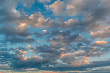 Clouds in the sky illuminated by the sun during sunset.
