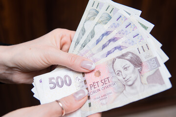 close-up of 500 czech koruna banknotes in female hands. Czech economy and finance