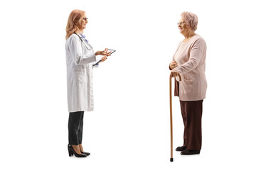 Fototapeta premium Full length profile shot of a female doctor talking to an elderly female patient