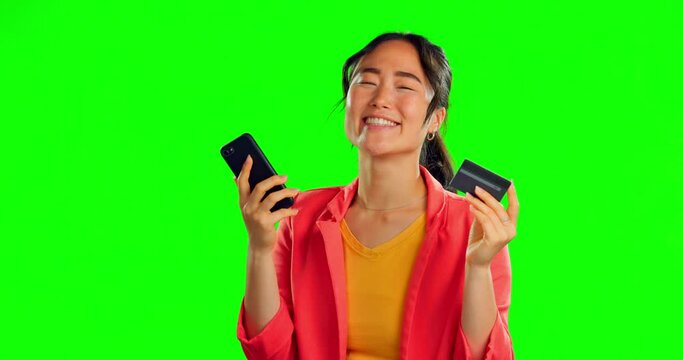Credit card, green screen and woman winning on a phone isolated on studio background bonus, loan or financial success. Happy Asian person or winner online shopping on cellphone with fintech banking