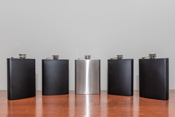 Five Black and Silver Metal Whisky Flasks 