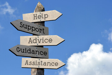 Help, support, advice, guidance, assistance - wooden signpost with five arrows, sky with clouds
