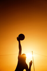 Silhouette Beach volleyball player woman doing serve kick on sunset