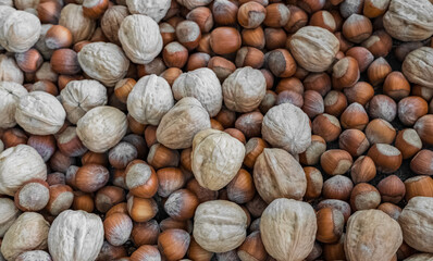 Assortment of nuts. Hazelnuts, walnuts mix for the background. Food mixed on wooden background, top view, copy space