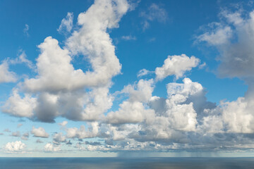 Fototapeta na wymiar White clouds in the sky and rain in the sea