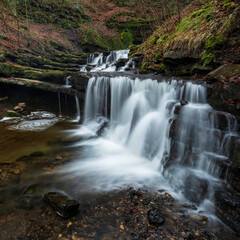 Beautiful peaceful landscape image of Scaleber Force waterfall in Yorkshire Dales in England during Winter morning