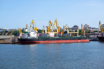 Port terminal of bulk cargo. Bulker vessel at the port terminal