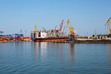 Fototapeta premium View of the seaport with containers elevator and bulk carrier