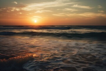 Obraz premium Ocean sea horizon a seascape and a skyscape. Soft sand, a sunset sky that is orange and golden, serenity, peaceful sunlight, and a summertime mood. Beautiful natural scenery with a vast horizon of sky