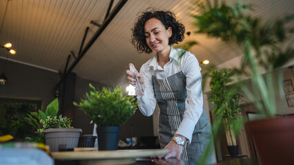 woman gardener florist take care grow cultivate plants at home