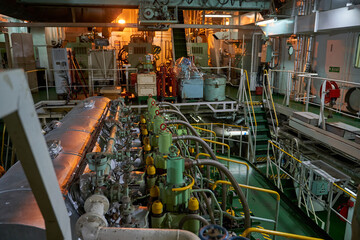 Ship's engine room. Vessel's ( Ship ) Engine Room Space / industrial stairs. Ship's Engine Heavy Machinery Space - Pipes, Valves, Engines