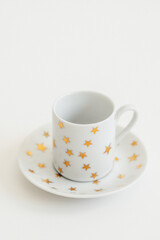 white espresso, Turkish coffee cup with gold stars on white background