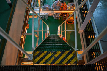 Ship's engine room. Vessel's ( Ship ) Engine Room Space / industrial stairs. Ship's Engine Heavy Machinery Space - Pipes, Valves, Engines